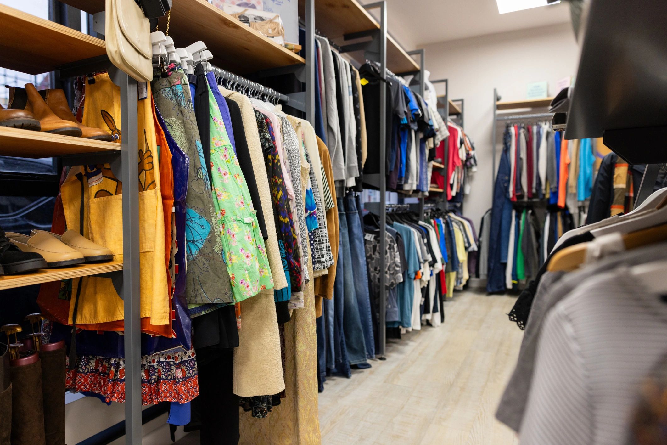 Interior view of a clothing shop with apparel racks