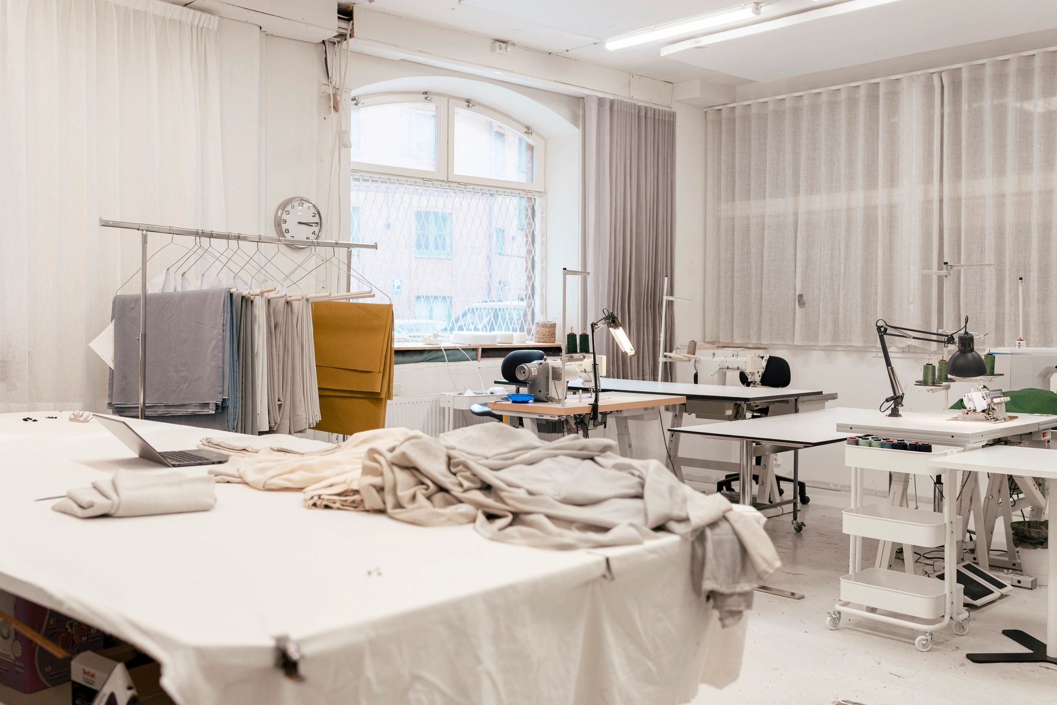 Bright garment workshop with fabrics and sewing machines